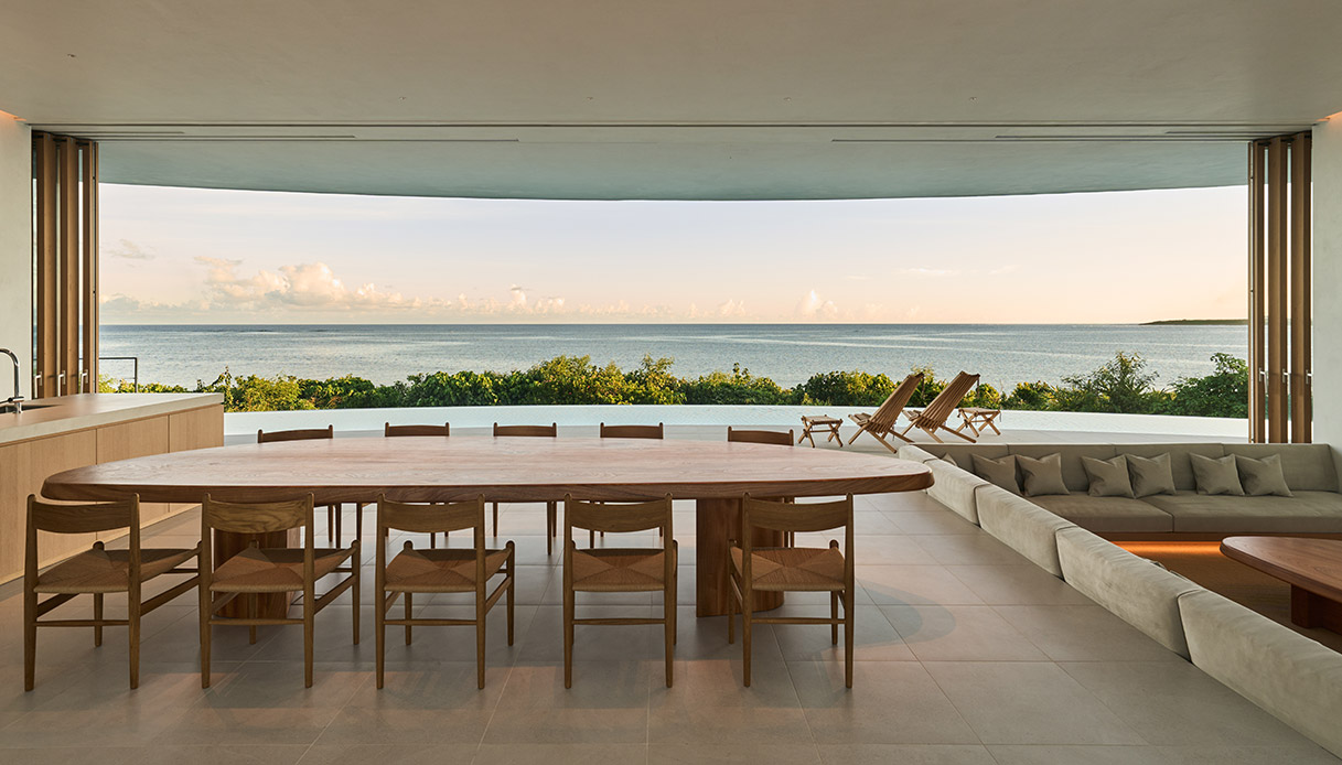 Salon de la villa Earth avec grandes fenêtres et vue mer